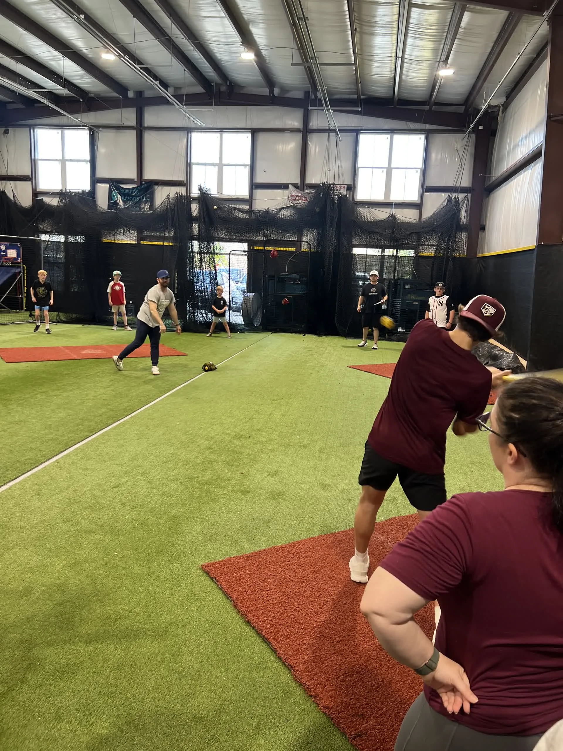 Kids and adults playing field games during a birthday party at Taylor'd Athletics