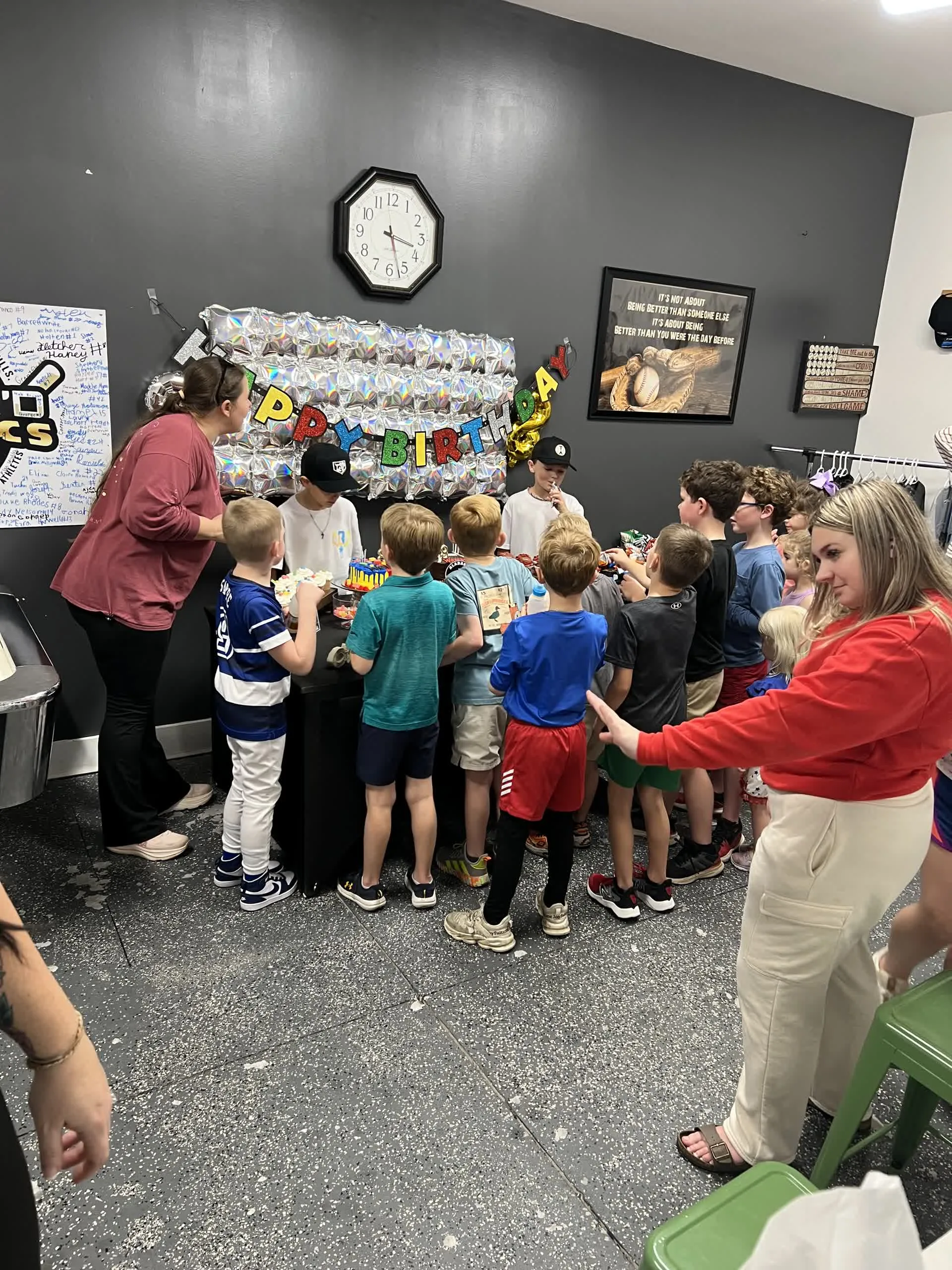 Kids crowded around the birthday treat station during a party at Taylor'd Athletics