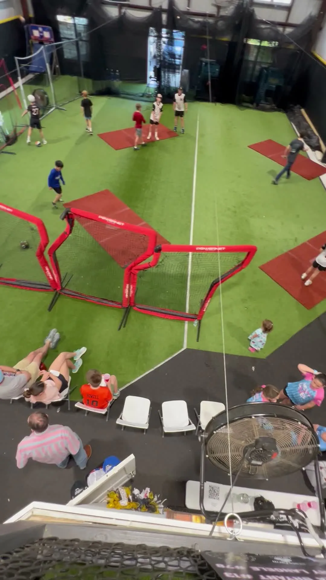 Overhead view of kids playing soccer birthday party games on the turf