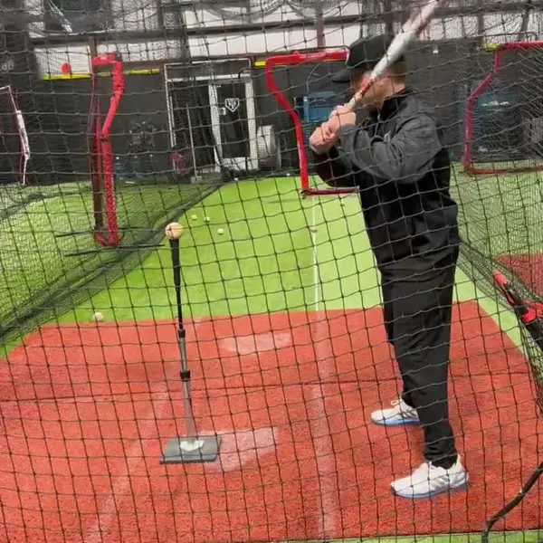 Coach Matt Taylor working one-on-one on hitting technique