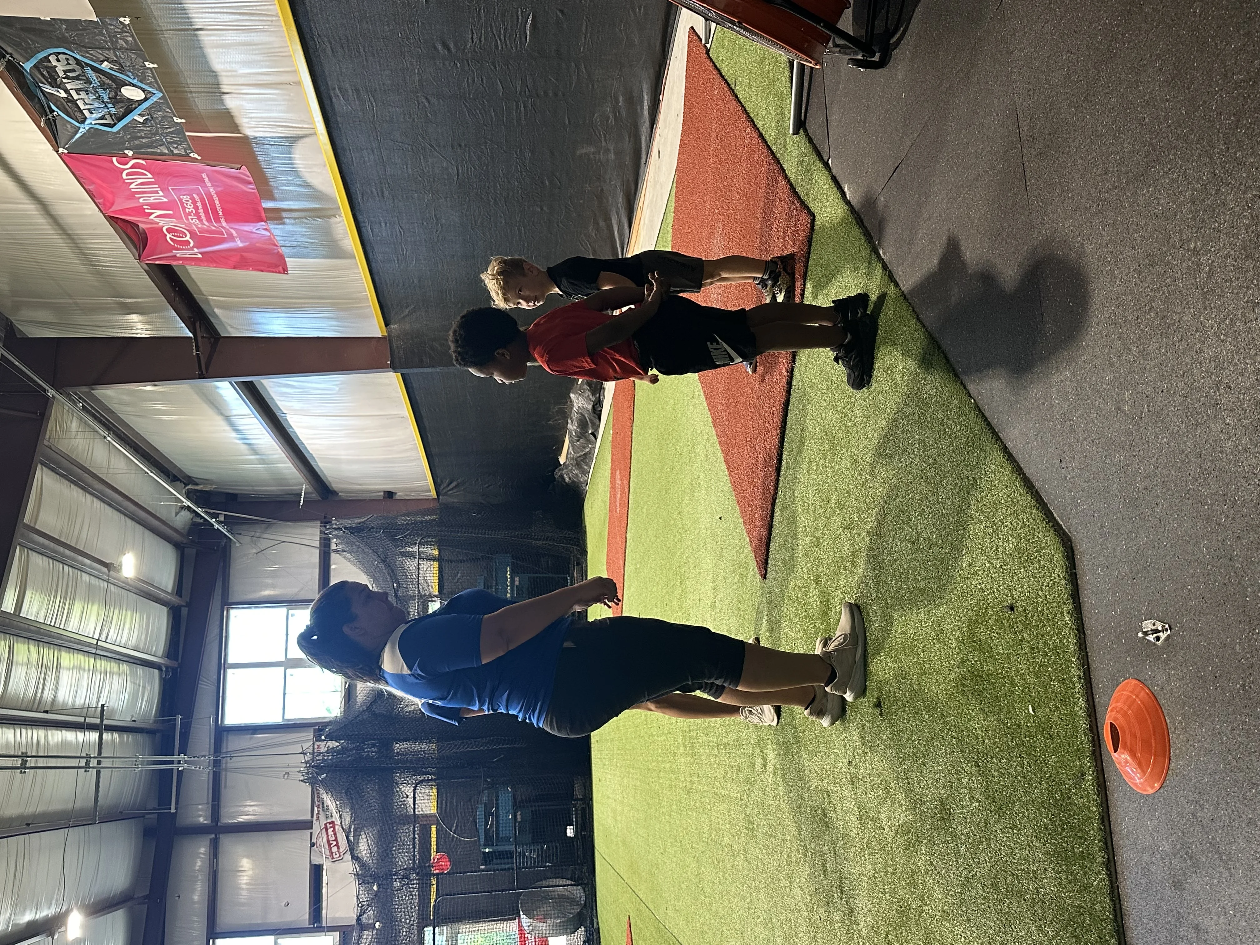 Kids doing movement drills on the indoor turf